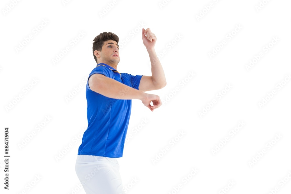 Football player in blue jersey jumping Football player in blue jersey jumping
