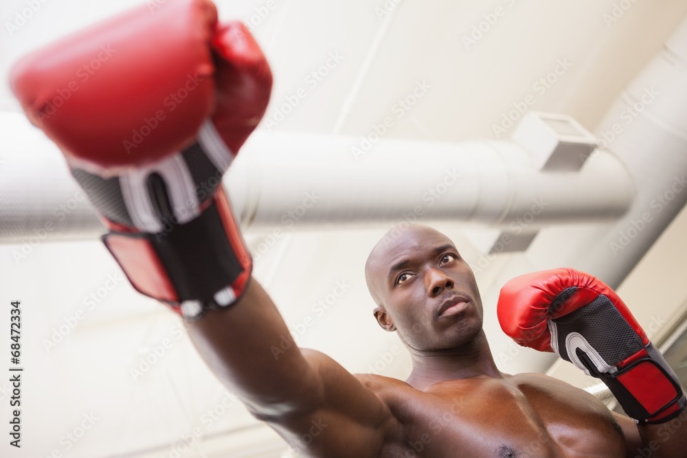 Male boxer attacking with his right in health club Male boxer attacking with his right in health club