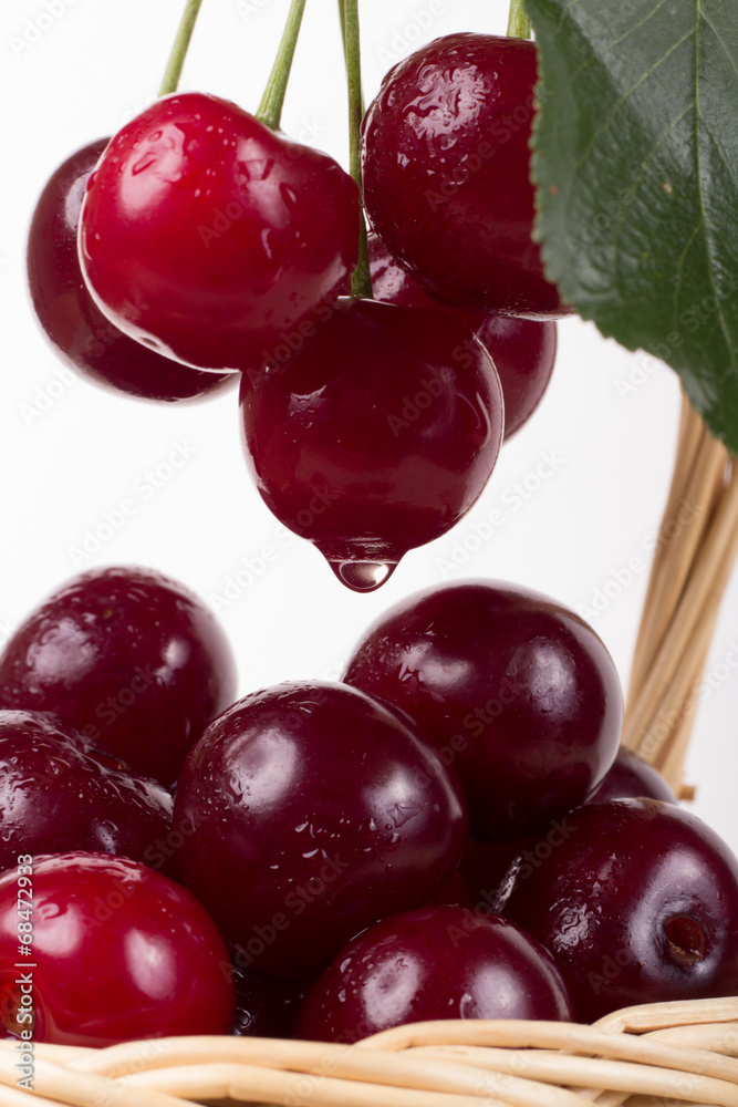 Basket with ripe cherry, currants and gooseberries isolated on w Basket with ripe cherry, currants and gooseberries isolated on w