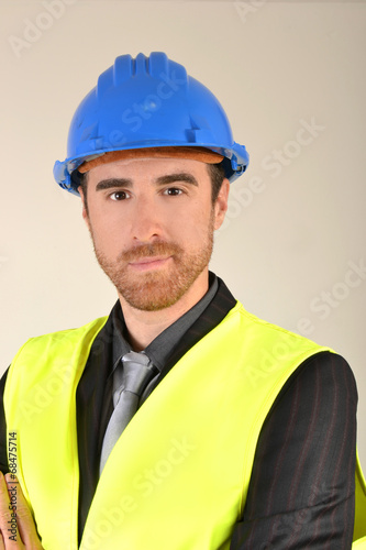 Businessman with construction helmet and reflective vest