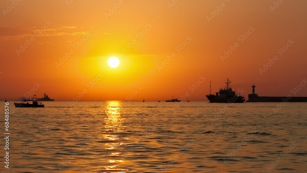Boats floating on the sea at sunset Boats floating on the sea at sunset