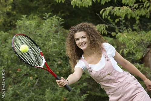 Teenage girl playing tennis
