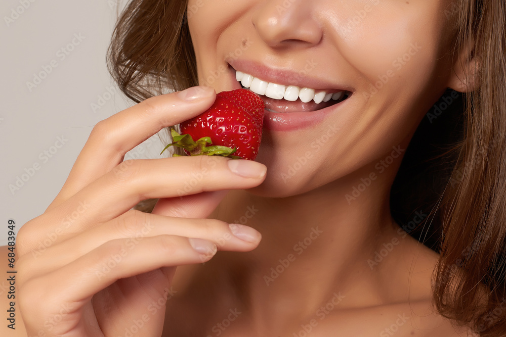 Beatiful girl with perfect smile eat healthy food red strawberry Beatiful girl with perfect smile eat healthy food red strawberry