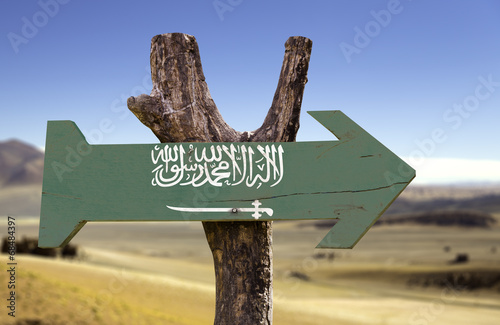 Saudi Arabia wooden sign with a desert background photo