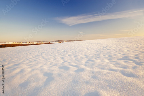  a field covered with white snow in a winter season