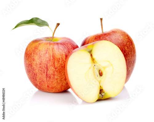 Close-up shot sliced red apple with leaf isolated