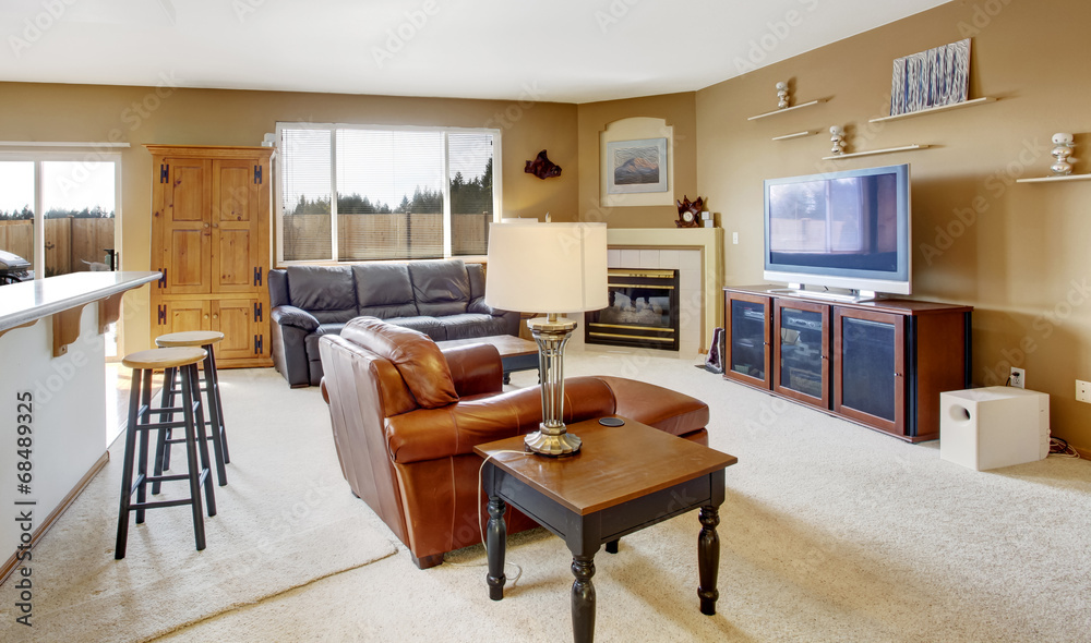 Cozy living room with fireplace and leather couch Cozy living room with fireplace and leather couch