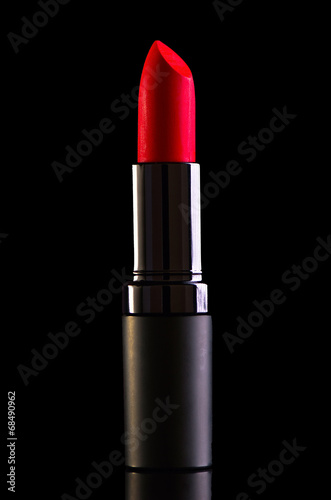 Red lipstick isolated on black background photo