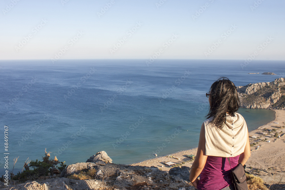 A girl looks the Tsambika beach