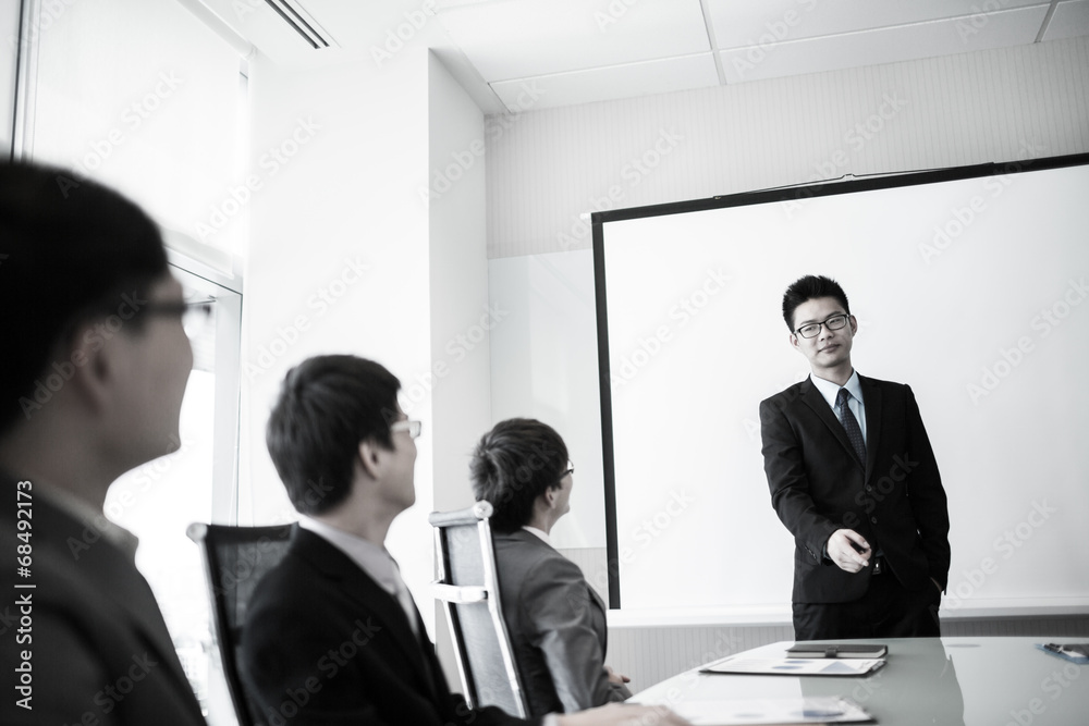 businessman giving a presentation to his colleagues businessman giving a presentation to his colleagues