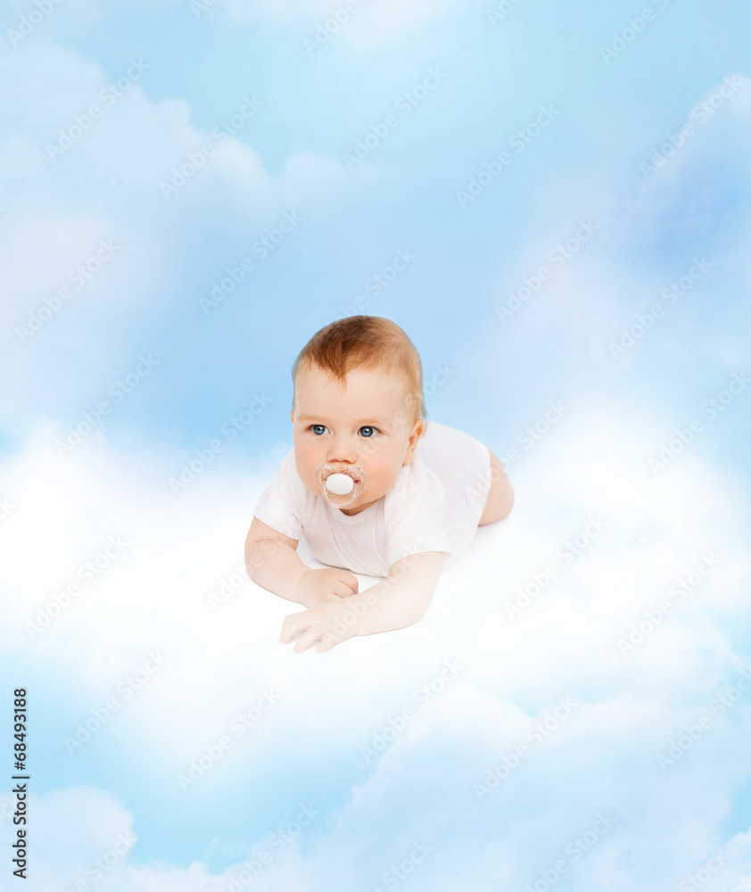 smiling baby lying on cloud with dummy in mouth smiling baby lying on cloud with dummy in mouth