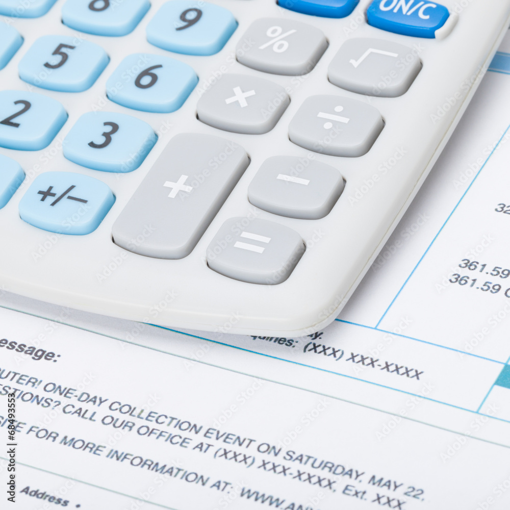 Receipt next to calculator - studio shot - 1 to 1 ratio Receipt next to calculator - studio shot - 1 to 1 ratio
