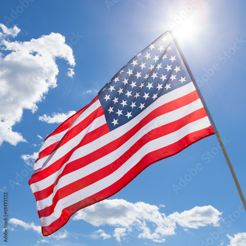 USA flag waving on blue sky background - 1 to 1 ratio