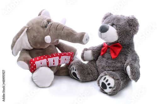 Sweet teddy bear and plush elephant on a white background