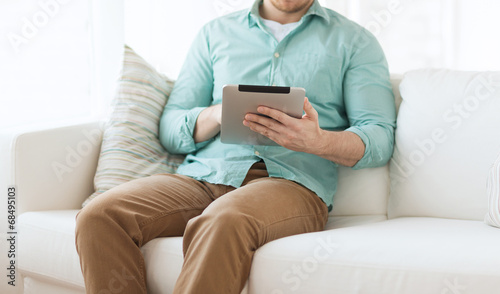 close up of man with tablet pc computer at home