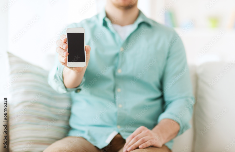 close up of man sitting with smartphone at home