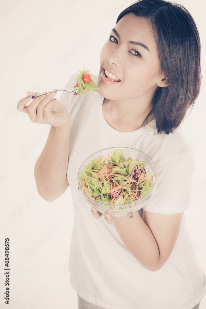 Pretty girl eating fresh vegetable salad Pretty girl eating fresh vegetable salad