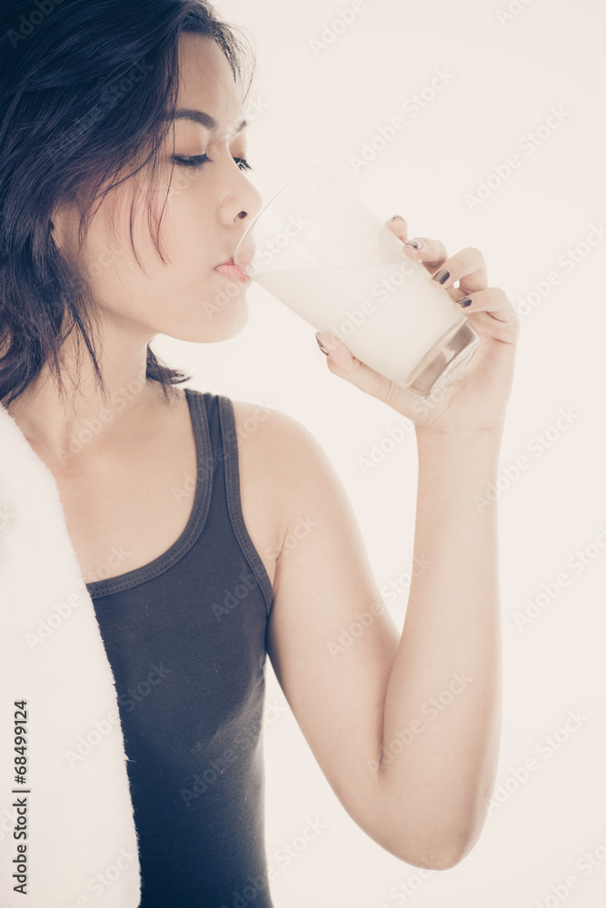 Laughing young woman with a glass of milk Laughing young woman with a glass of milk