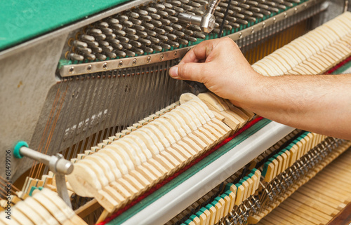 Detailed view of Upright Piano during a tuning photo