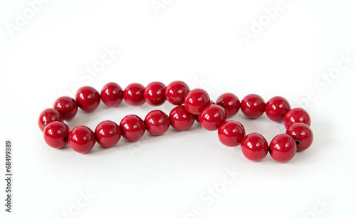 vintage red beads coloured in red isolated on white background w