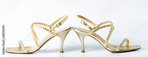 Woman golden shoes on white