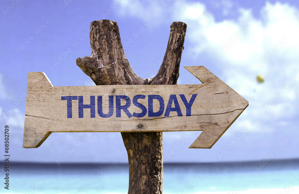 Thursday wooden sign with a beach on background