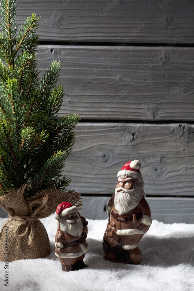 Obraz premium Schokonikoläusen und Weihnachtsbaum auf Schnee