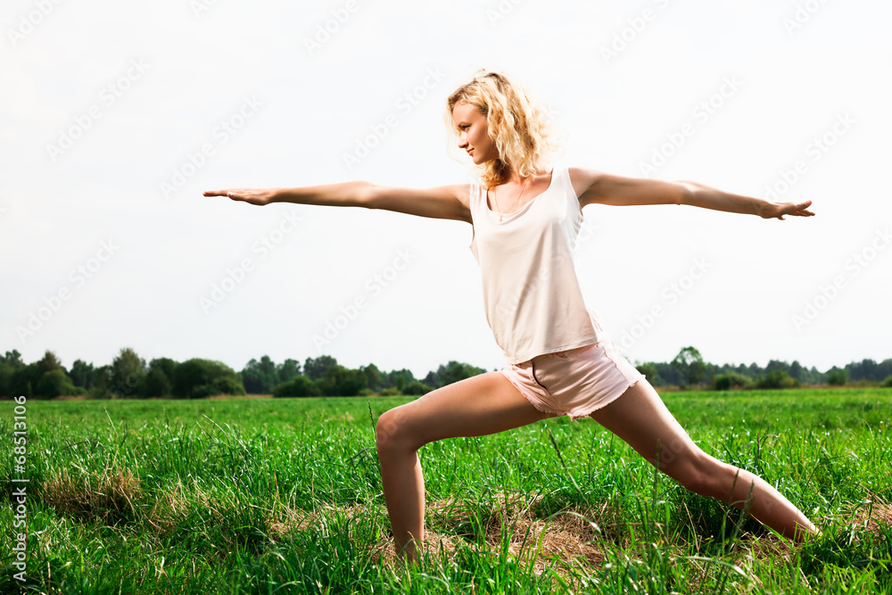 Beautiful young woman doing yoga exercise on field. Beautiful young woman doing yoga exercise on field.