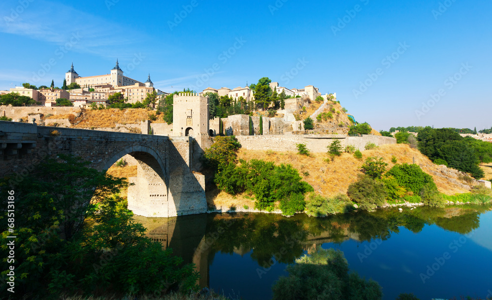 Day view of Puente de Alcantara - ancient  bridge in Toledo.