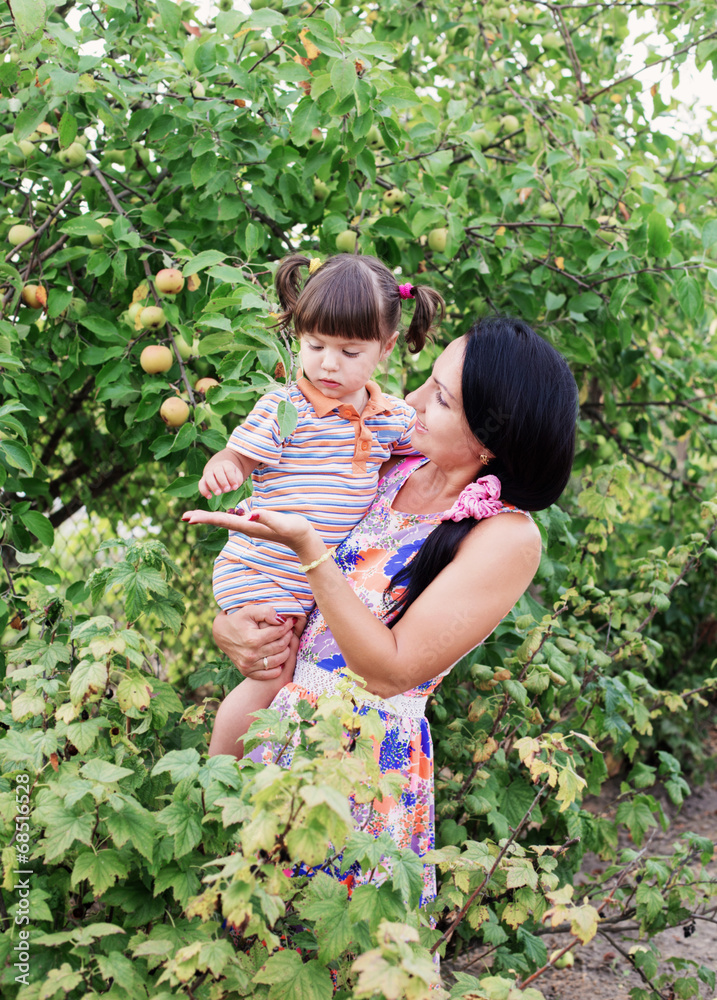 happy women and little child with berries happy women and little child with berries