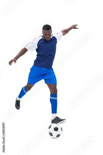 Football player in blue kicking ball © WavebreakMediaMicro