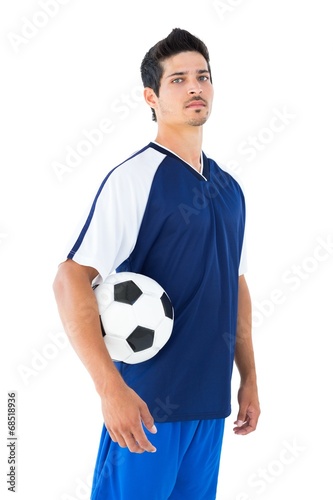 Football player in blue holding the ball © WavebreakMediaMicro