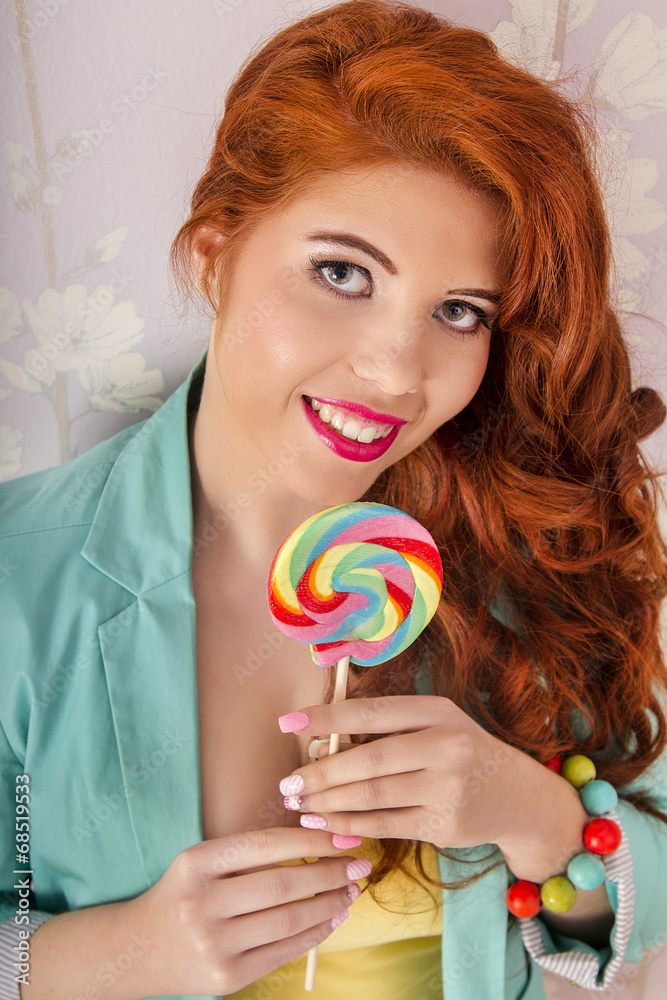 redhead girl with a lollipop candy 