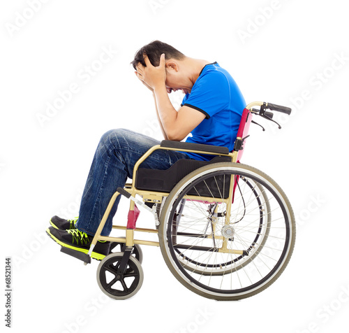 Canvas Print upset  and handicapped man sitting on a wheelchair