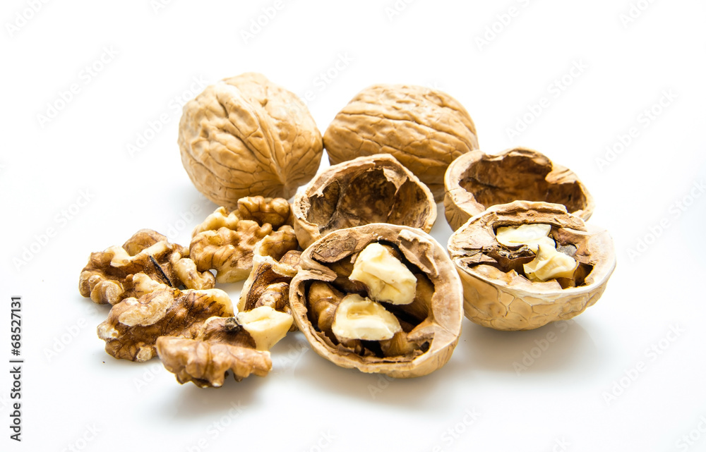 walnut and a cracked walnut on the white background walnut and a cracked walnut on the white background