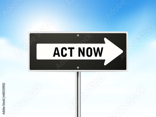 act now on black road sign