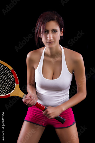 Beautiful young girl with a tennis racquet 