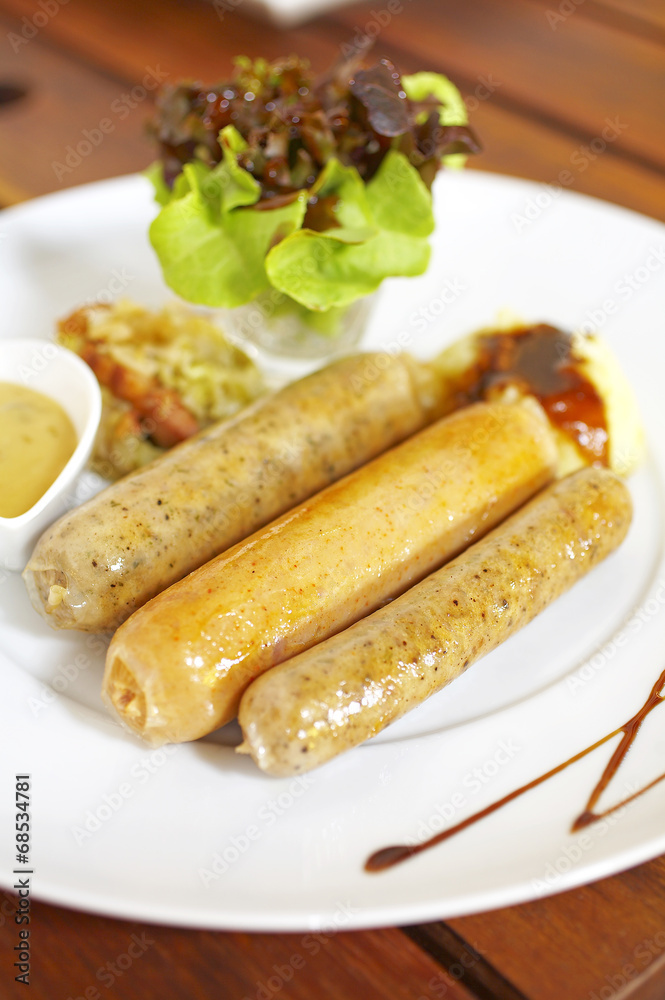 close up german smoked sausage on white background close up german smoked sausage on white background
