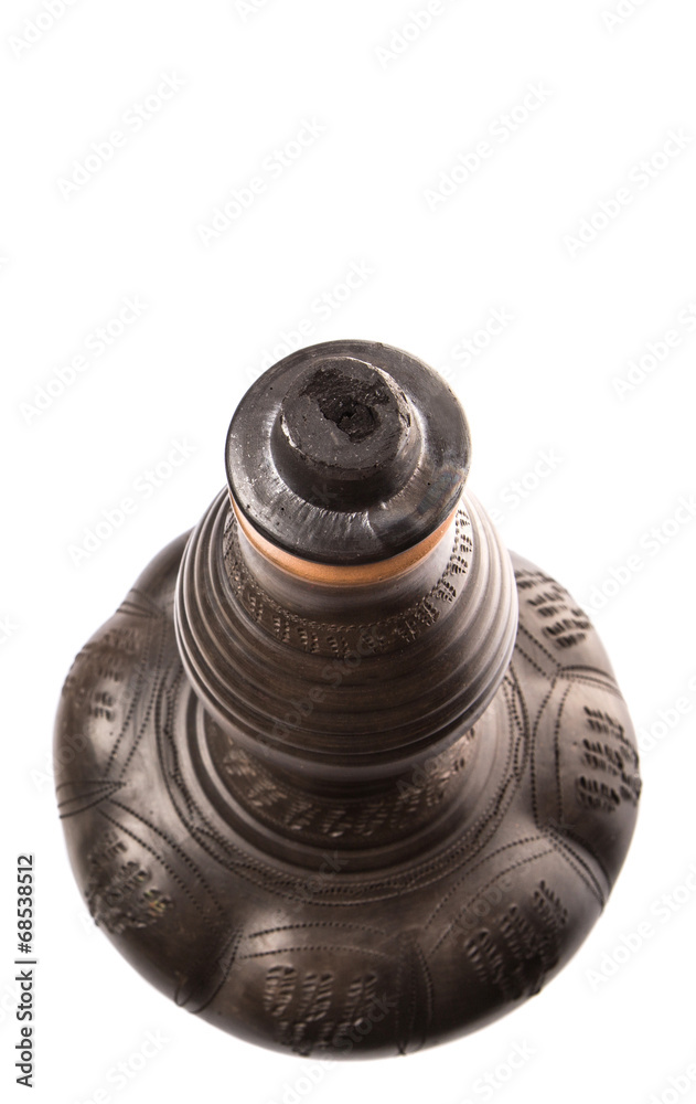 Black clay water pitcher over white background Black clay water pitcher over white background