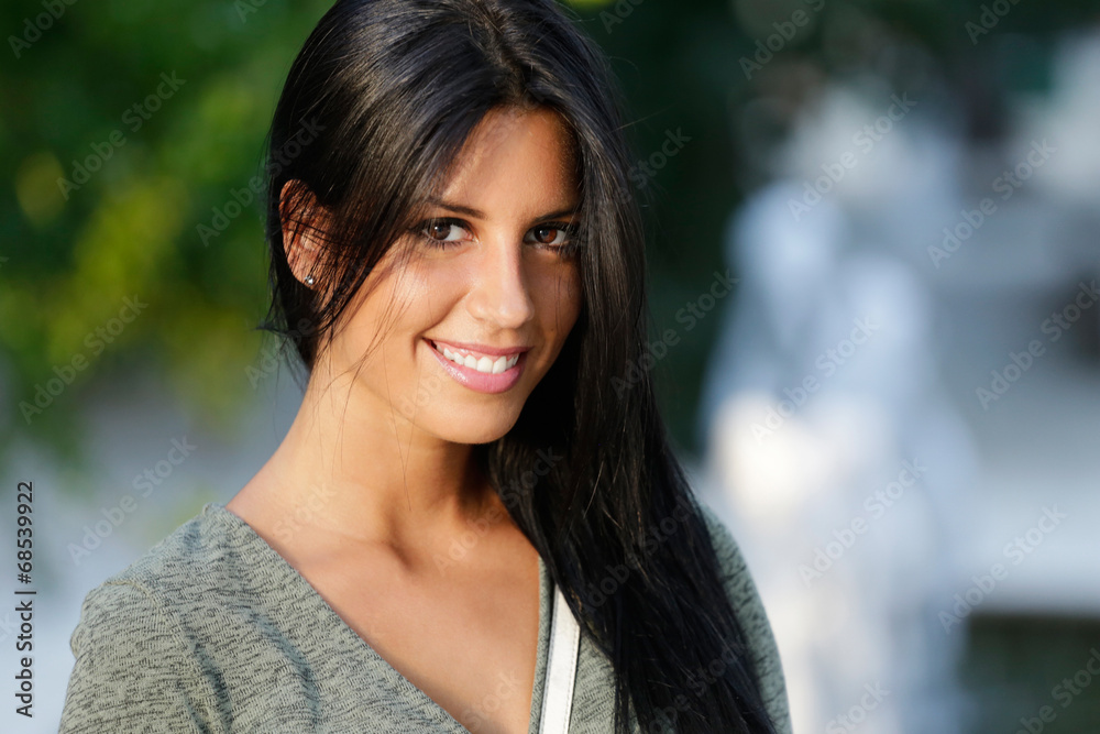 Beautiful girl posing at camera in the park. Beautiful girl posing at camera in the park.