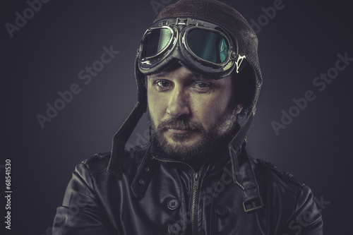 steampunk pilot dressed in vintage style leather cap and goggles