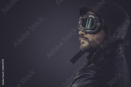 Tela portrait pilot dressed in vintage style leather cap and goggles