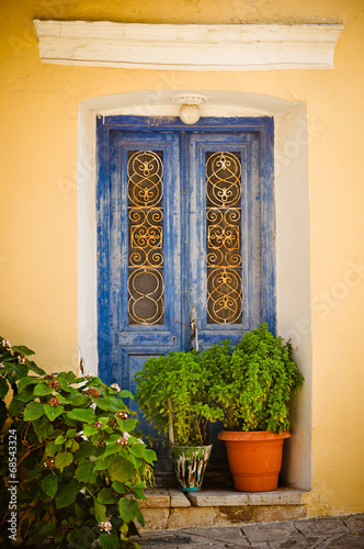 Ornamental blue doors, Samos, Greece © Mangojuicy
