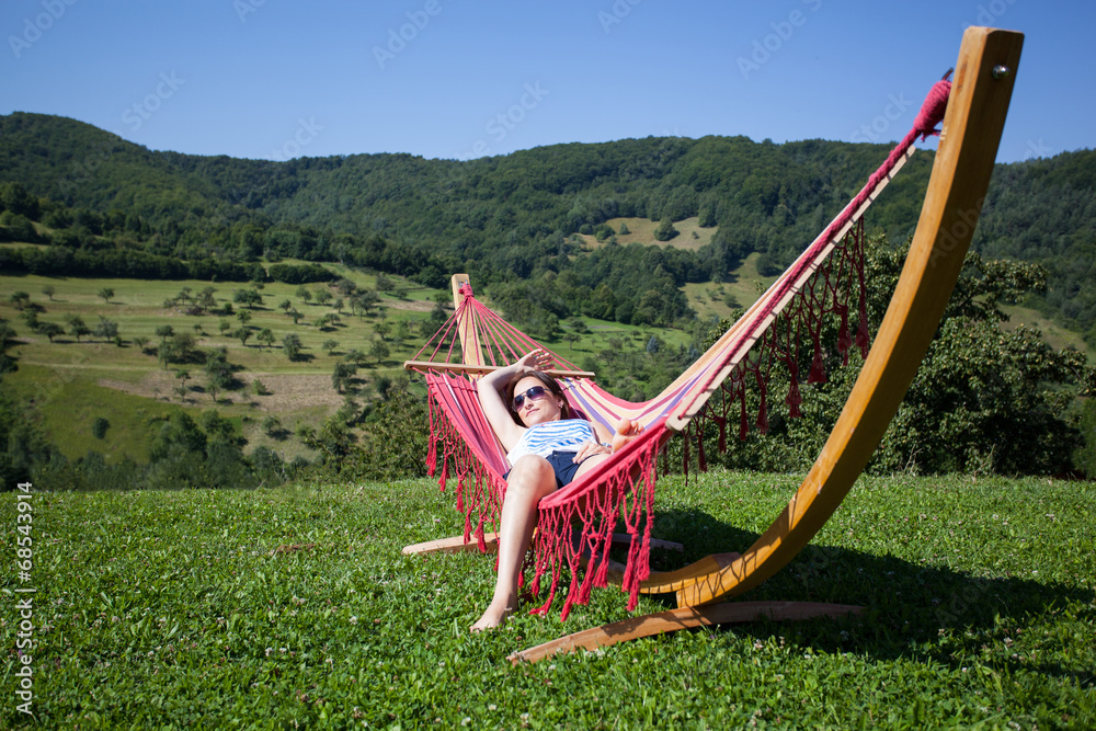 Young female relaxing in a hammock Young female relaxing in a hammock