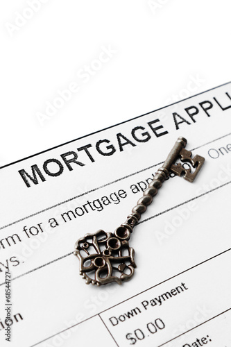 Vintage key against mortgage agreement
