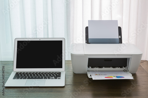 printer and Laptop on wood table