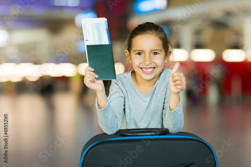 little girl giving thumb up at airport