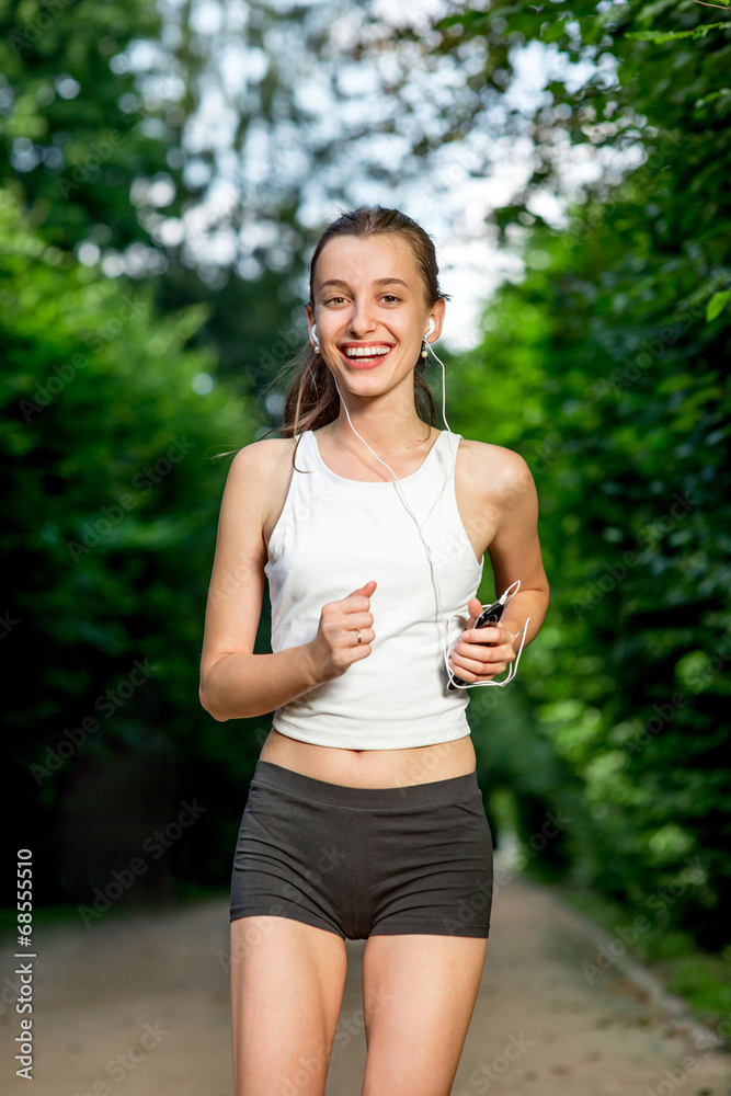 Running woman. Female runner jogging during outdoor workout in a