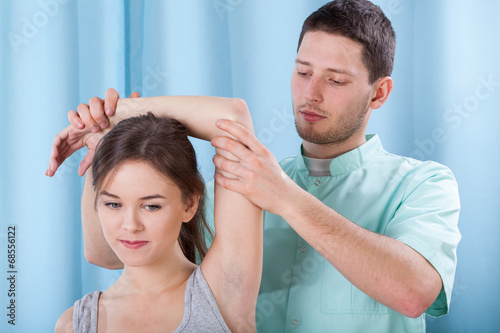 Physiotherapist holding the upper limb photo