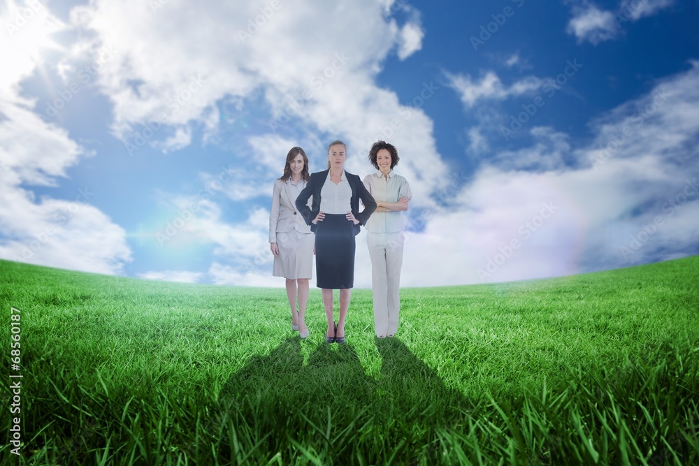 Composite image of team of businesswomen looking at camera